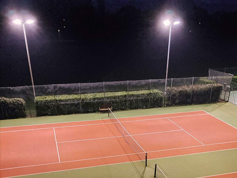 Tennis Court at Night Illuminated by Flood Lights